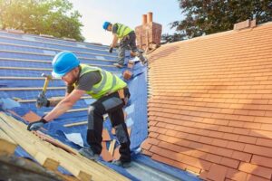 A group of men working on a roof in Logan, Utah